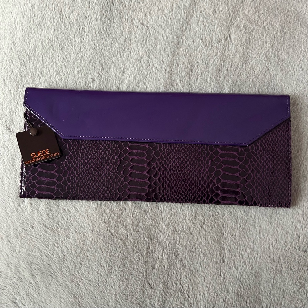 Suede hand bag in the colour purple.